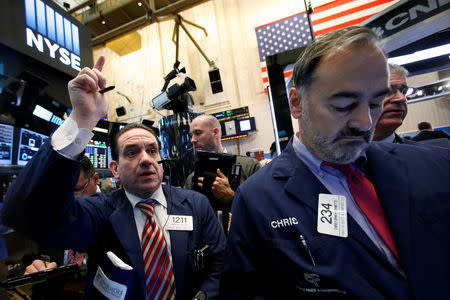 Traders work on the floor of the New York Stock Exchange (NYSE) in New York City, U.S., November 23, 2016. REUTERS/Brendan McDermid