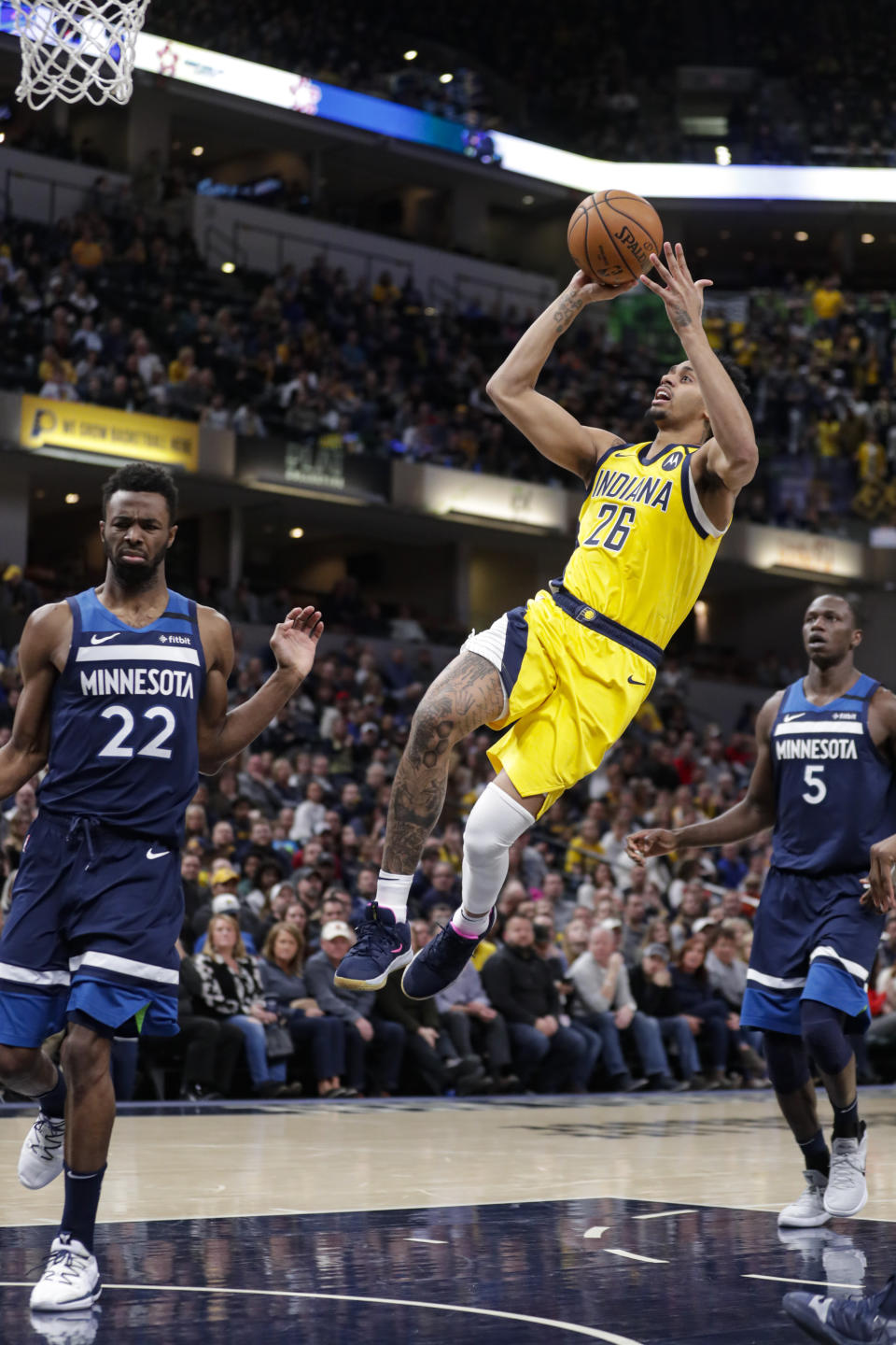 Indiana Pacers guard Jeremy Lamb (26) shoots between Minnesota Timberwolves forward Andrew Wiggins (22) and center Gorgui Dieng (5) during the second half of an NBA basketball game in Indianapolis, Friday, Jan. 17, 2020. The Pacers won 116-114. (AP Photo/Michael Conroy)