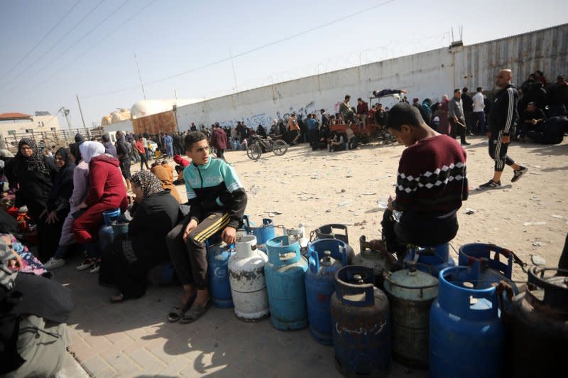 Palestinians queue in front of a gas station to fill cooking cylinders in Rafah, southern Gaza, on Sunday after the arrival of 150 trucks of aid supplies to the Gaza Strip. Photo by Ismael Muhammad/UPI