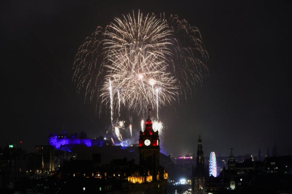 Fireworks light up the sky over Edinburgh Castle and the Balmoral Hotel Clock for Hogmanay (REUTERS)