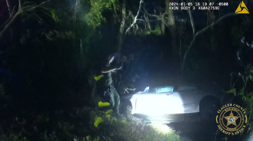 A vehicle drove off into a flooded ditch after a crash on a Florida road, trapping two inside, deputies said.