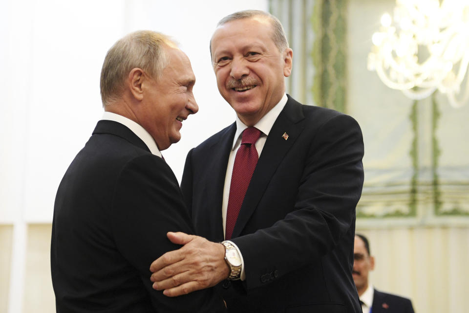 Turkey's President Recep Tayyip Erdogan, right, and Russia's President Vladimir Putin, greets each other in Tehran, Iran, prior to their talks as part of Russia-Iran-Turkey summit to discuss Syria, Friday Sept. 7, 2018. Putin, Erdogan and Iran's President Hassan Rouhani began a meeting Friday in Tehran to discuss the war in Syria. (Kirill Kudryavtsev/Pool Photo via AP)