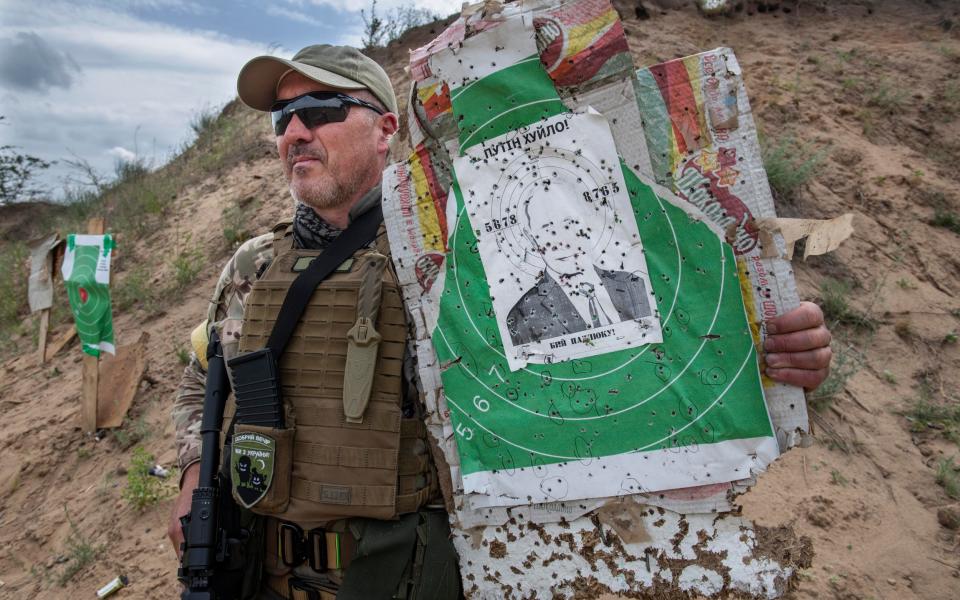 Vladimir Putin is at the centre of a paper target used by volunteers with the Kherson Brigade to hone their shooting skills - Julian Simmonds for The Telegraph