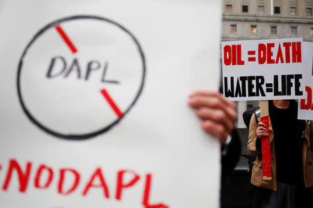 Demonstrators hold signs as they gather in New York to protest against plans to pass the Dakota Access pipeline near the Standing Rock Indian Reservation in North Dakota, U.S., November 15, 2016. REUTERS/Shannon Stapleton