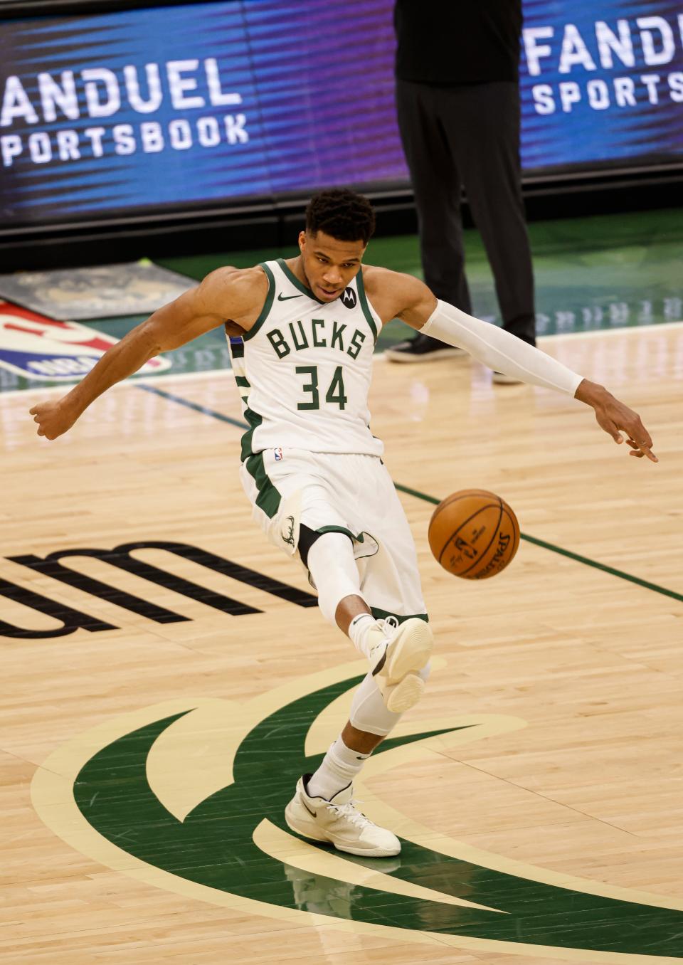 Milwaukee Bucks forward Giannis Antetokounmpo playfully kicks the ball after getting fouled by the Miami Heat during the second half of Game 2 of their NBA basketball first-round playoff series Monday, May 24, 2021, in Milwaukee.