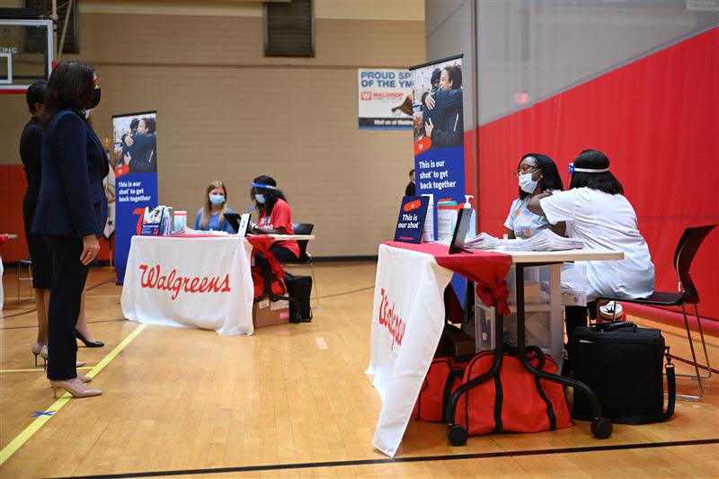 Vice President Kamala Harris speaks with Kaitlyn Ward, as Angela Godfrey administers a vaccine shot at Caine Halter Family YMCA in Greenville on Monday, June 14, 2021.