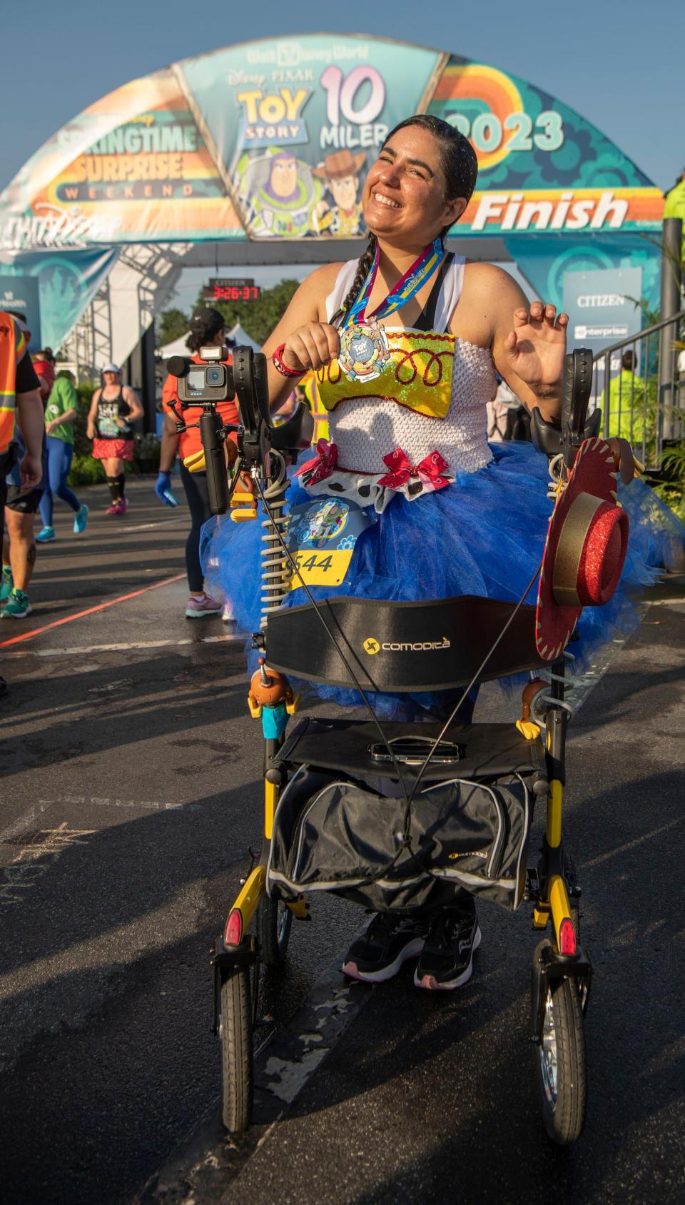 Nathalia Paradise of Tampa defied the odds when she completed the Disney Pixar Toy Story 10-Miler during runDisney Springtime Surprise Weekend on April 16, 2023, in Lake Buena Vista, Fla. The Army veteran recently suffered a severe spinal injury but overcame those difficulties by using a walker to successfully finish the final on-site race of the 2022-23 runDisney race season. (Kent Phillips, photographer)