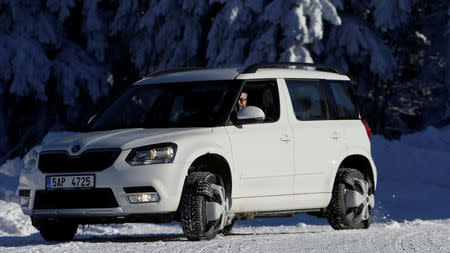 Automatic snow chains are mounted on the tires of a car driving through the ski resort Ovcarna near the village of Karlova Studanka, Czech Republic, January 19, 2017. REUTERS/David W Cerny