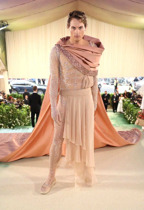 <p>Kevin Mazur/MG24/Getty Images</p><p>The Norwegian salmon farming billionaire arrived in this beige, gladiator ensemble complete with a massive cape and cowl. </p>