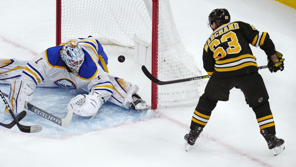 Boston Bruins left wing Brad Marchand (63) backhands the puck over Buffalo Sabres goaltender Ukko-Pekka Luukkonen (1) on a shot, that stayed out of the net during the first period of an NHL hockey game, Thursday, March 2, 2023, in Boston. (AP Photo/Charles Krupa)