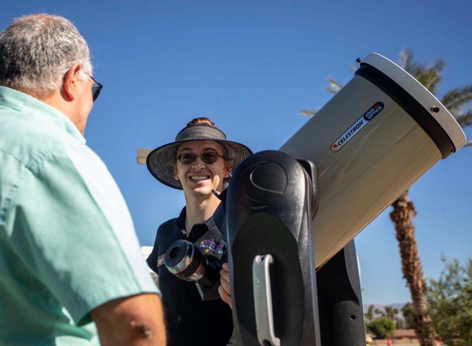 Eric McLaughlin, astronomer with the Rancho Mirage Library & Observatory, helps a guest get a view of the solar eclipse through one of the observatory's telescopes Saturday at Rancho Mirage Community Park.
