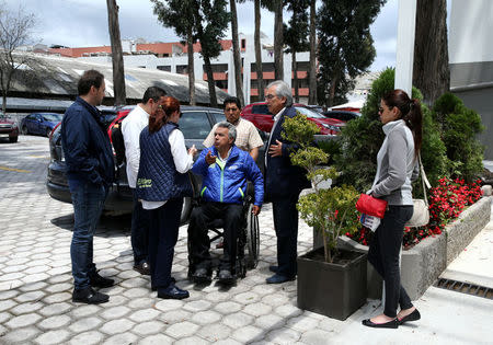 Lenin Moreno (C), presidential candidate of the ruling PAIS Alliance Party, talks to members of his campaign team before a news conference in Quito, Ecuador, February 21, 2017. REUTERS/Mariana Bazo