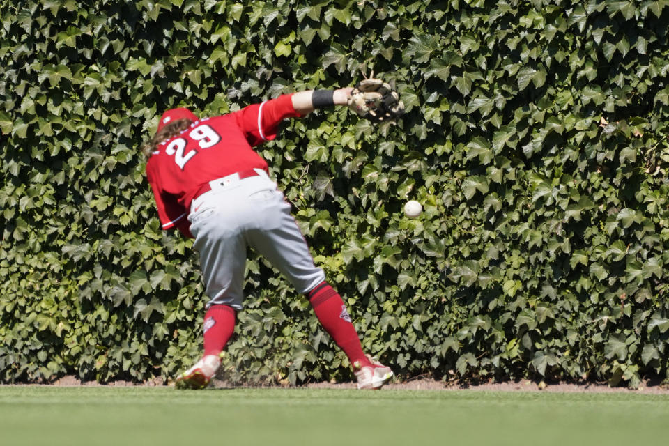 Cincinnati Reds center fielder TJ Friedl (29) can't catch a double hit by Chicago Cubs' Seiya Suzuki (27) during the sixth inning of a baseball game, Thursday, Sept. 8, 2022, in Chicago. (AP Photo/David Banks)