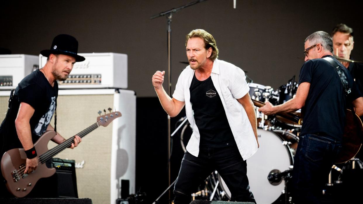 Eddie Vedder, Jeff Ament (L) and Stone Gossard (R) of Pearl Jam perform on stage