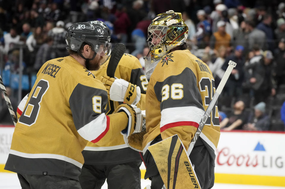 Vegas Golden Knights center Phil Kessel, left, congratulates Vegas Golden Knights goaltender Logan Thompson after the third period of an NHL hockey game against the Colorado Avalanche, Monday, Jan. 2, 2023, in Denver. (AP Photo/David Zalubowski)