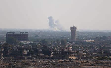 Smoke rises in Egypt's North Sinai as seen from the border of southern Gaza Strip with Egypt July 1, 2015. Islamic State militants launched a wide-scale coordinated assault on several military checkpoints in Egypt's North Sinai on Wednesday in which 50 people were killed, security sources said, the largest attack yet in the insurgency-hit province. REUTERS/Ibraheem Abu Mustafa TPX IMAGES OF THE DAY