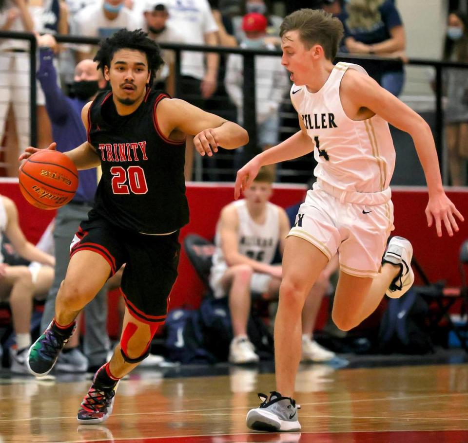 Trinity guard Malachi Farr (20) gets past Keller gaurd Grayson Price (4) during the second half of a 6A Bi-District High School Basketball playoff game played Monday, February 22, 2021 at Colleyville Heritage High School. (Steve Nurenberg Special to the Star-Telegram)