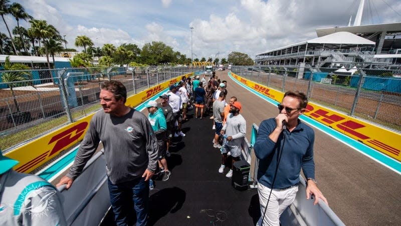 Dolphins Hall of Fame quarterback Dan Marino, left, and team President Tom Garfinkel lead a group of Dolphins players and coaches Monday on a tour of the Formula One track around Hard Rock Stadium.