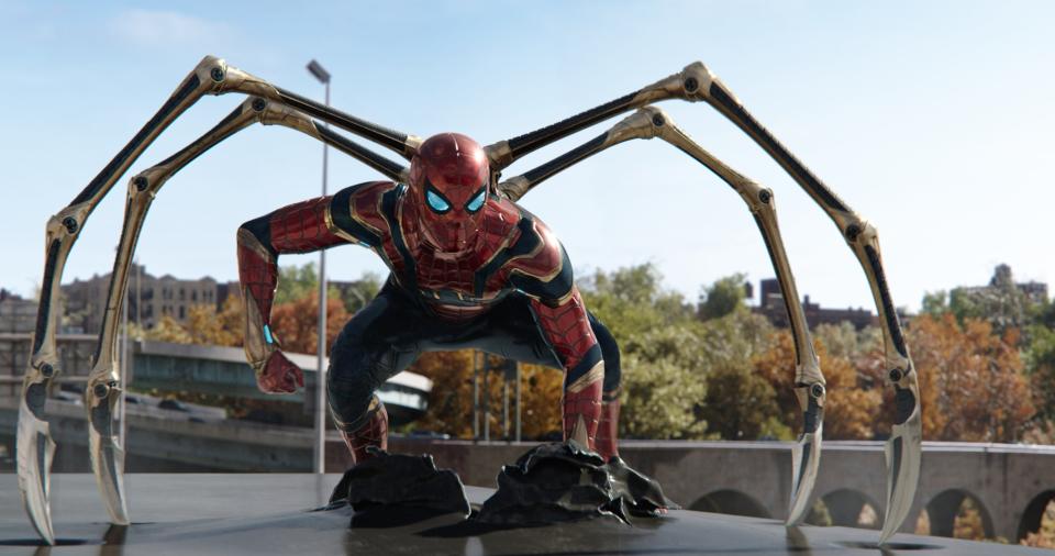 Tom Holland wearing the Spider-Man suit with iron legs in "Spider-Man: No Way Home."