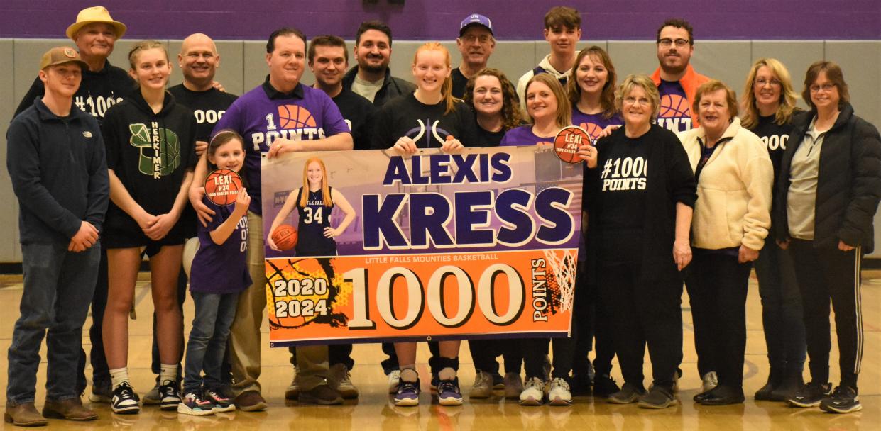 Junior Alexis Kress scored the 1,000th point of her varsity career during the final minute of the Little Falls Mounties' 58-35 victory over the Herkimer Magicians Monday. After the game, Kress (center) posed for this photo with friends and family.