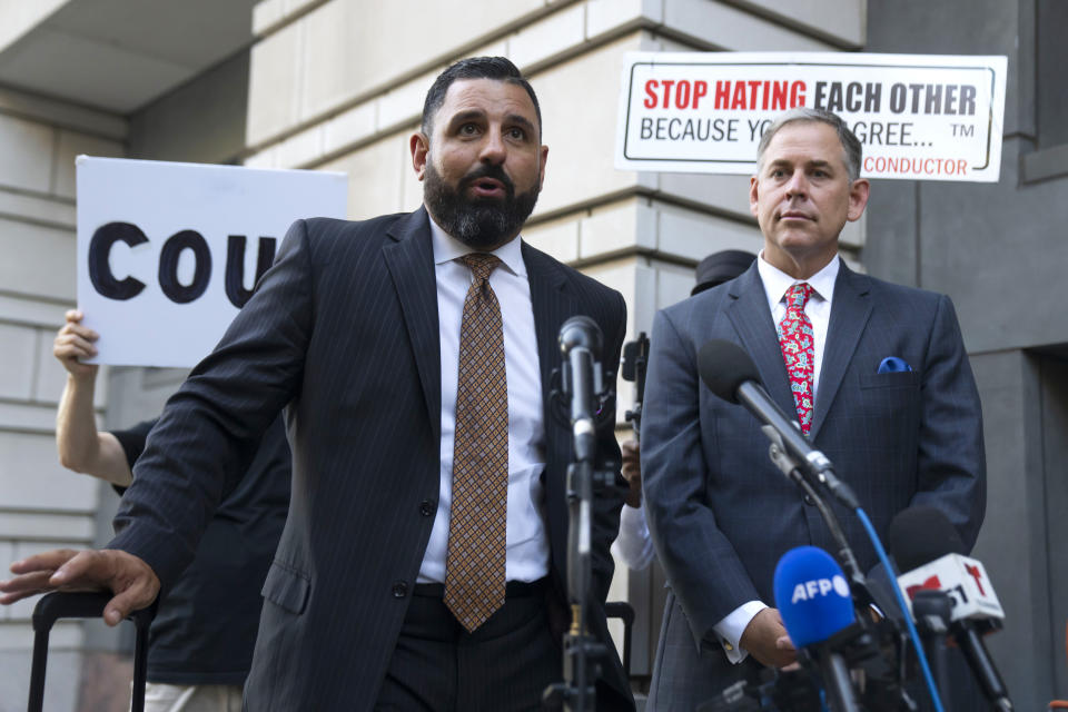 Attorneys for Enrique Tarrio, Nayib Hassan, left, and Sabino Jauregui speak to the media as they depart federal court, Tuesday, Sept. 5, 2023, in Washington. Former Proud Boys leader Enrique Tarrio has been sentenced to 22 years in prison for orchestrating a failed plot to keep Donald Trump in power after the Republican lost the 2020 presidential election. (AP Photo/Mark Schiefelbein)