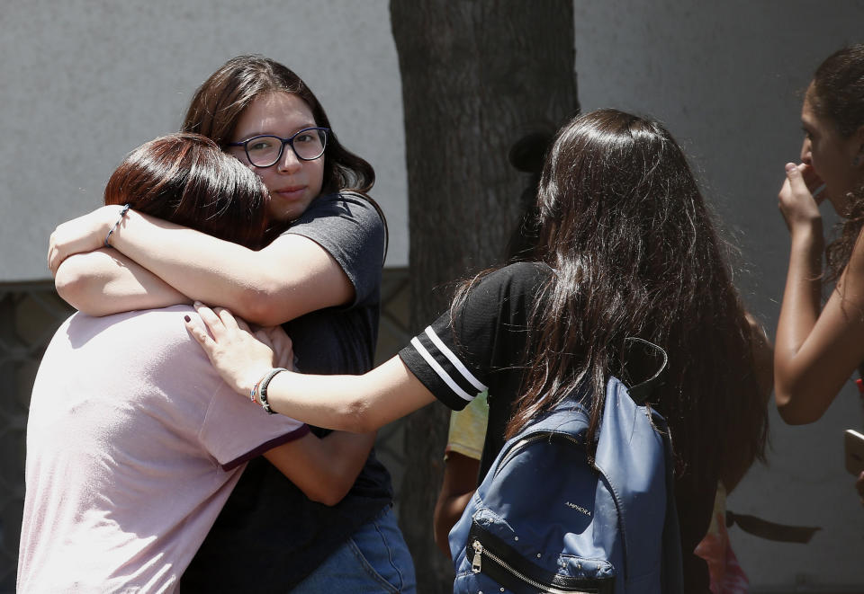 Relatives of passengers of a missing military plane comfort each other as they arrive at the Cerrillos airbase in Santiago, Chile, Tuesday, Dec. 10, 2019. Chile's air force said it lost radio contact with a C-130 Hercules transport plane carrying 38 people on a flight to the country's base in Antarctica, and authorities are indicating they are not optimistic about the aircraft's fate. (AP Photo/Luis Hidalgo)