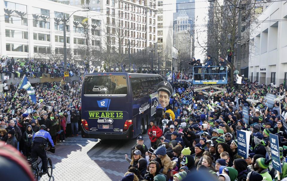 Seattle Seahawks fans line the street during the Super Bowl champions parade on Wednesday, Feb. 5, 2014, in Seattle. The Seahawks beat the Denver Broncos 43-8 in NFL football's Super Bowl XLVIII on Sunday. (AP Photo/Ted S. Warren)