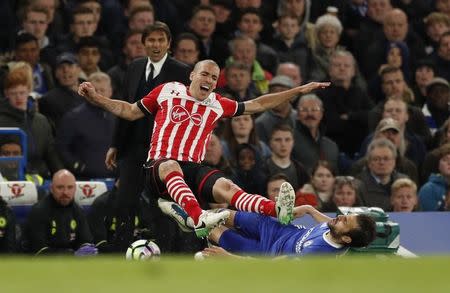 Britain Football Soccer - Chelsea v Southampton - Premier League - Stamford Bridge - 25/4/17 Southampton's Oriol Romeu is fouled by Chelsea's Cesc Fabregas as manager Antonio Conte looks on Action Images via Reuters / John Sibley Livepic