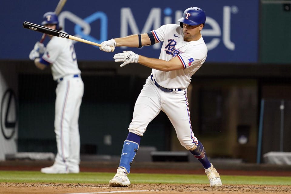 Texas Rangers' Nathaniel Lowe follows through on a single in the sixth inning of a baseball game against the Oakland Athletics in Arlington, Texas, Tuesday, Aug. 16, 2022. (AP Photo/Tony Gutierrez)