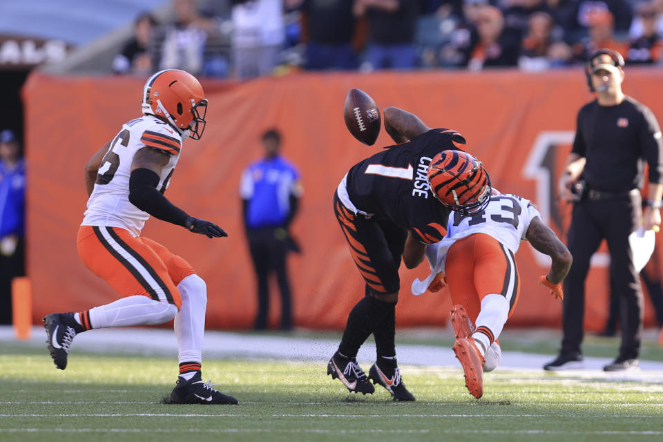 Cincinnati Bengals' Ja'Marr Chase (1) fumbles as he is hit by Cleveland Browns' John Johnson (43) during the first half of an NFL football game, Sunday, Nov. 7, 2021, in Cincinnati. (AP Photo/Aaron Doster)