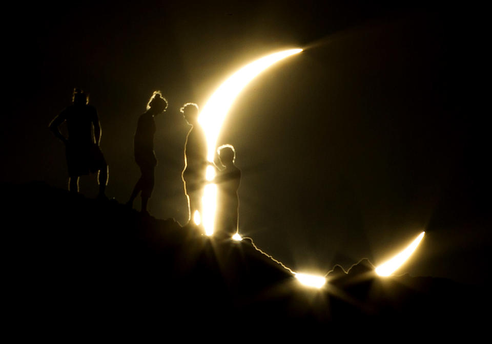 Hikers watch an annular eclipse from Papago Park in Phoenix, Arizona. The annular eclipse, in which the moon passes in front of the sun leaving only a golden ring around its edges, was seen across China, Japan and elsewhere in the region before moving across the Pacific to be seen in parts of the western U.S.