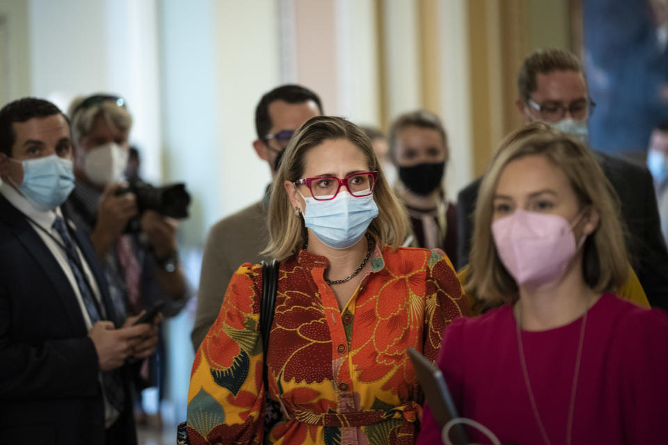 WASHINGTON, DC - OCTOBER 07: Sen. Kyrsten Sinema (D-AZ) walks to a lunch meeting with Senate Democrats at the U.S. Capitol October 7, 2021 in Washington, DC. Senate Democrats and Republicans are nearing a deal that will temporarily raise the debt ceiling through early December. (Photo by Drew Angerer/Getty Images)