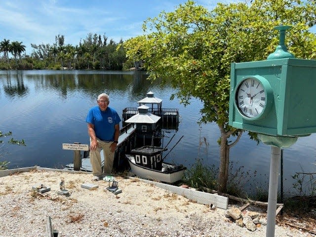 Larry Gessman, 75, stands near the model of the Fort Myers Beach pier and the Fort Myers Beach Times Square replica clock at Lakes Park. Gessman and other volunteers have been working on rebuilding models featured along the popular train ride at the park. They were damaged when Hurricane Ian hit Fort Myers on Sept. 28, 2022.