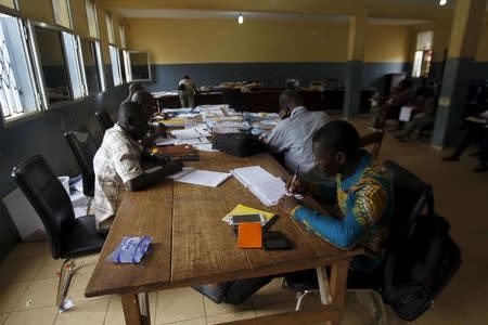 Election officials examine votes at a results centralization center at Ratoma two days after a presidential election in Conakry, Guinea October 14, 2015. REUTERS/Luc Gnago