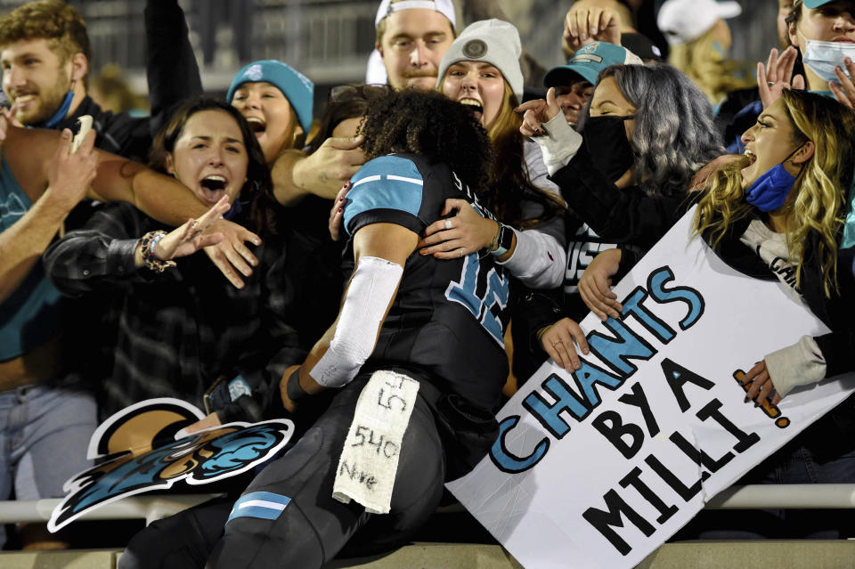 Coastal Carolina's Isaiah Stephens, center, celebrates with fans after an NCAA college football game against BYU, Saturday, Dec. 5, 2020, in Conway, S.C. (AP Photo/Richard Shiro)