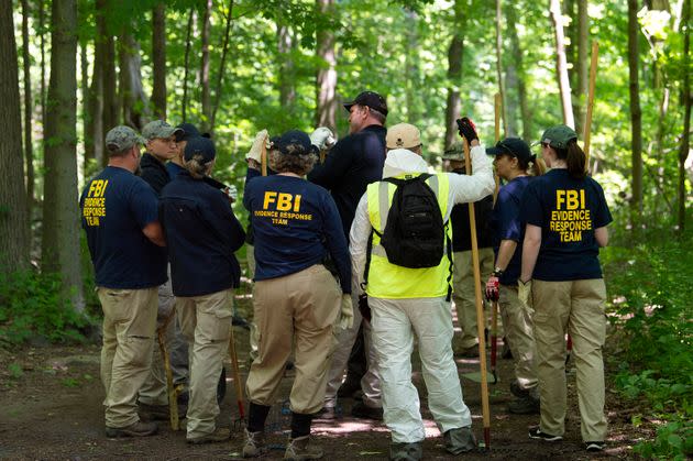 An FBI team combs a heavily wooded area in Waveny Park in New Canaan, Connecticut, on June 3, 2019.