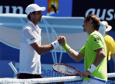 David Ferrer (R) of Spain shakes hands with Jeremy Chardy of France after winning their men's singles match at the Australian Open 2014 tennis tournament in Melbourne January 17, 2014. REUTERS/Petar Kujundzic