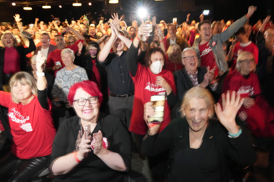 Supporters cheer at a Labor Party event following the close of the polling places in Sydney, Australia, Saturday, May 21, 2022. Australians voted following a six-week election campaign that has focused on pandemic-fueled inflation, climate change and fears of a Chinese military outpost being established less than 1,200 miles off Australia's shore. (AP Photo/Rick Rycroft)