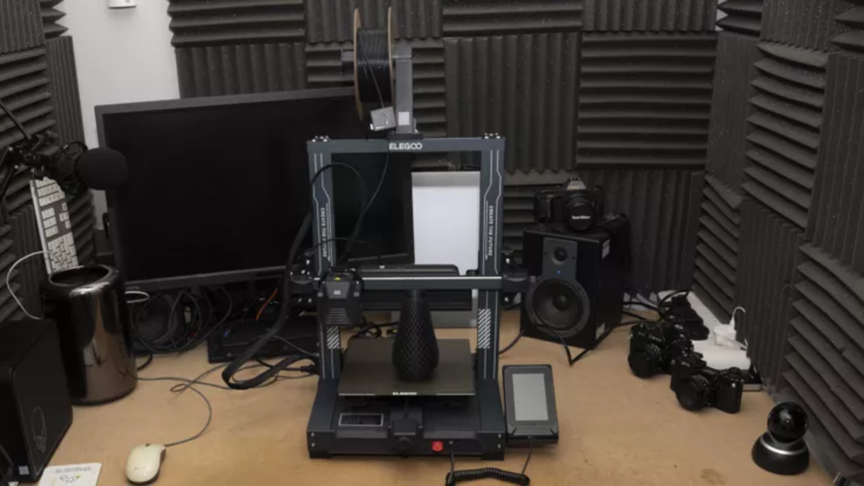  Elegoo Neptune 4 Pro 3D printer on a desk in a padded sound booth  