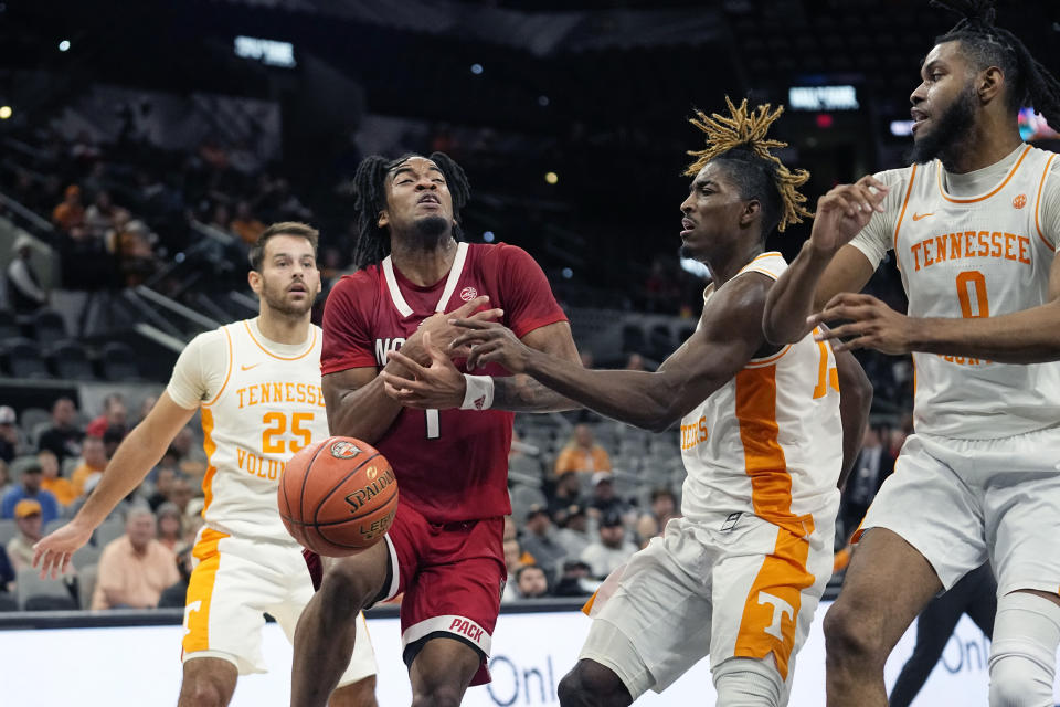 North Carolina State guard Jayden Taylor (1) is fouled by Tennessee guard Jahmai Mashack, second from right, during the first half of an NCAA college basketball game in San Antonio, Saturday, Dec. 16, 2023. (AP Photo/Eric Gay)