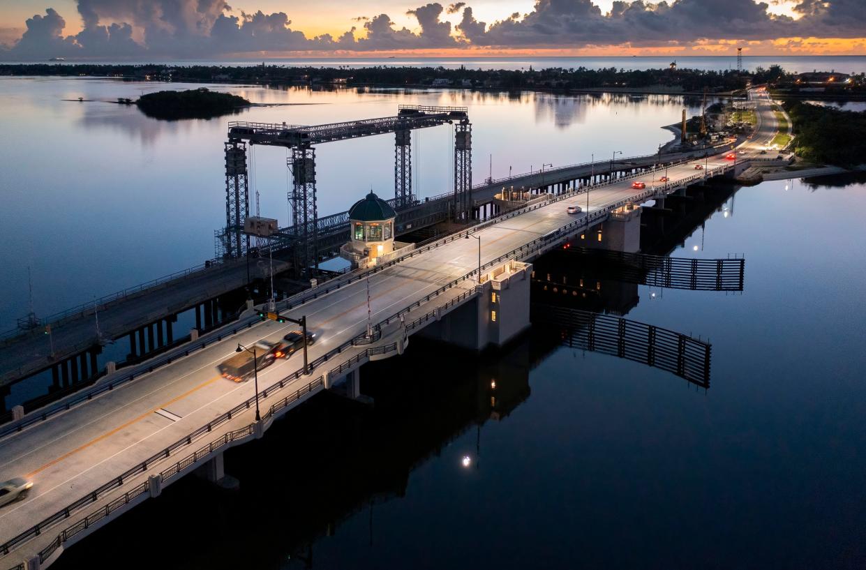 Cars drive over the Southern Boulevard bridge that connects West Palm Beach and Palm Beach.