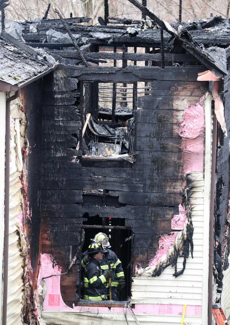 Firefighters work at the scene of an early morning fire on Lake St. in Spring Valley March 4, 2023. Five people died in the fire.