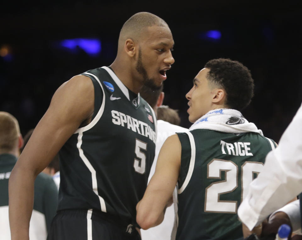 Michigan State's Adreian Payne, left, and Travis Trice celebrate after Michigan State defeated Virginia 61-59 in a regional semifinal of the NCAA men's college basketball tournament, early Saturday, March 29, 2014, in New York. (AP Photo/Frank Franklin II)