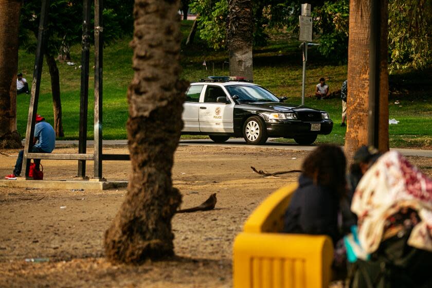 LOS ANGELES, CA - AUGUST 11: Police patrol MacArthur Park a location that has become an important source of revenue for the MS-13 gang, whose members "tax," or extort, drug dealers, gamblers, sex workers and others for permission to operate within the park on Wednesday, Aug. 11, 2021 in Los Angeles, CA. (Jason Armond / Los Angeles Times)