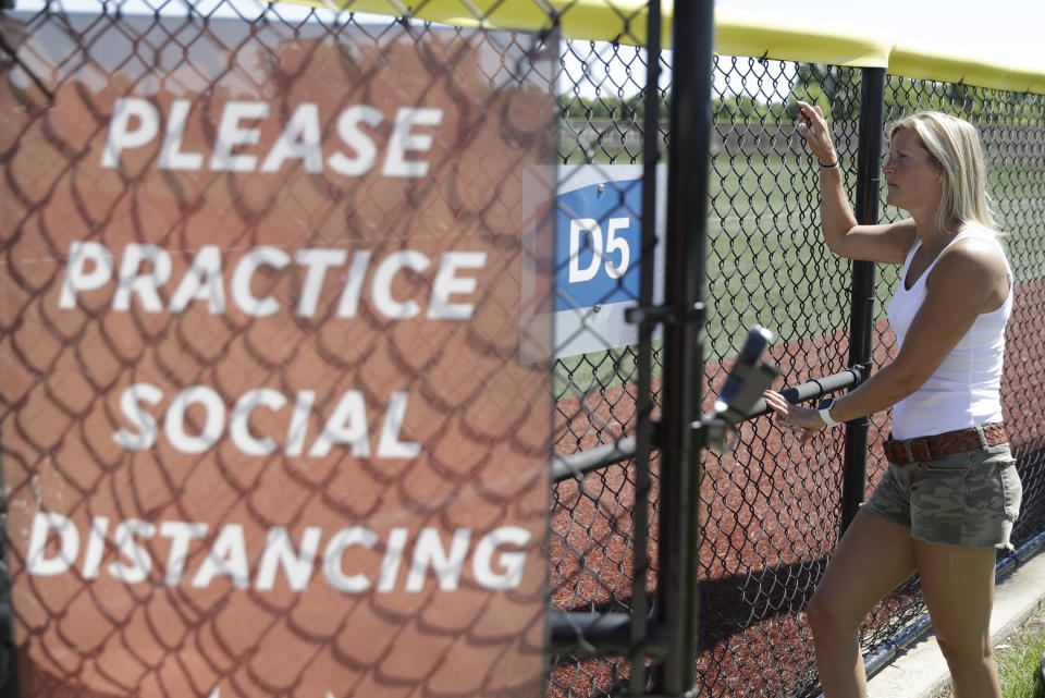Kate Nunley watches as professional and college players workout at Grand Park, Friday, June 12, 2020, in Westfield, Ind. Proceeds from the event will go to Reviving Baseball in the Inner City of Indianapolis. (AP Photo/Darron Cummings)