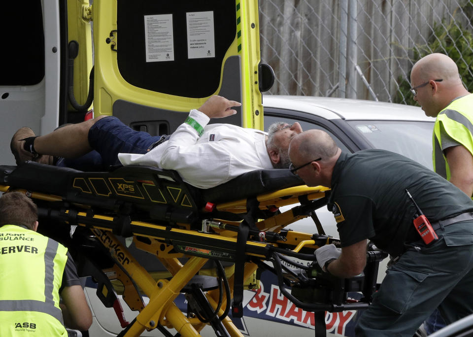FILE - Ambulance staff take a man from outside a mosque in central Christchurch, New Zealand, March 15, 2019, following a mass shooting. An inquiry that began Tuesday, Oct. 24, 2023 into New Zealand’s worst mass-shooting will examine, among other issues, the response times of police and medics and whether any of the 51 people who were killed could have been saved. (AP Photo/Mark Baker, File)