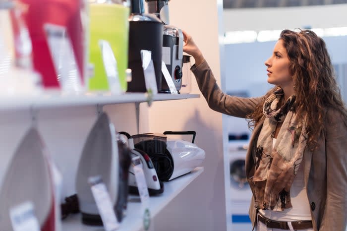 A person shopping for household goods in a store.