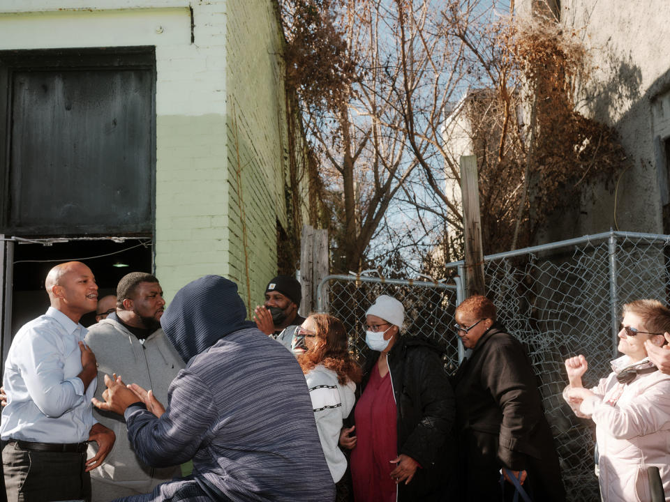 Moore hands bags of food out to individuals during a visit to the Ruth M. Kirk Recreation and Learning Center in Baltimore<span class="copyright">Jared Soares for TIME</span>