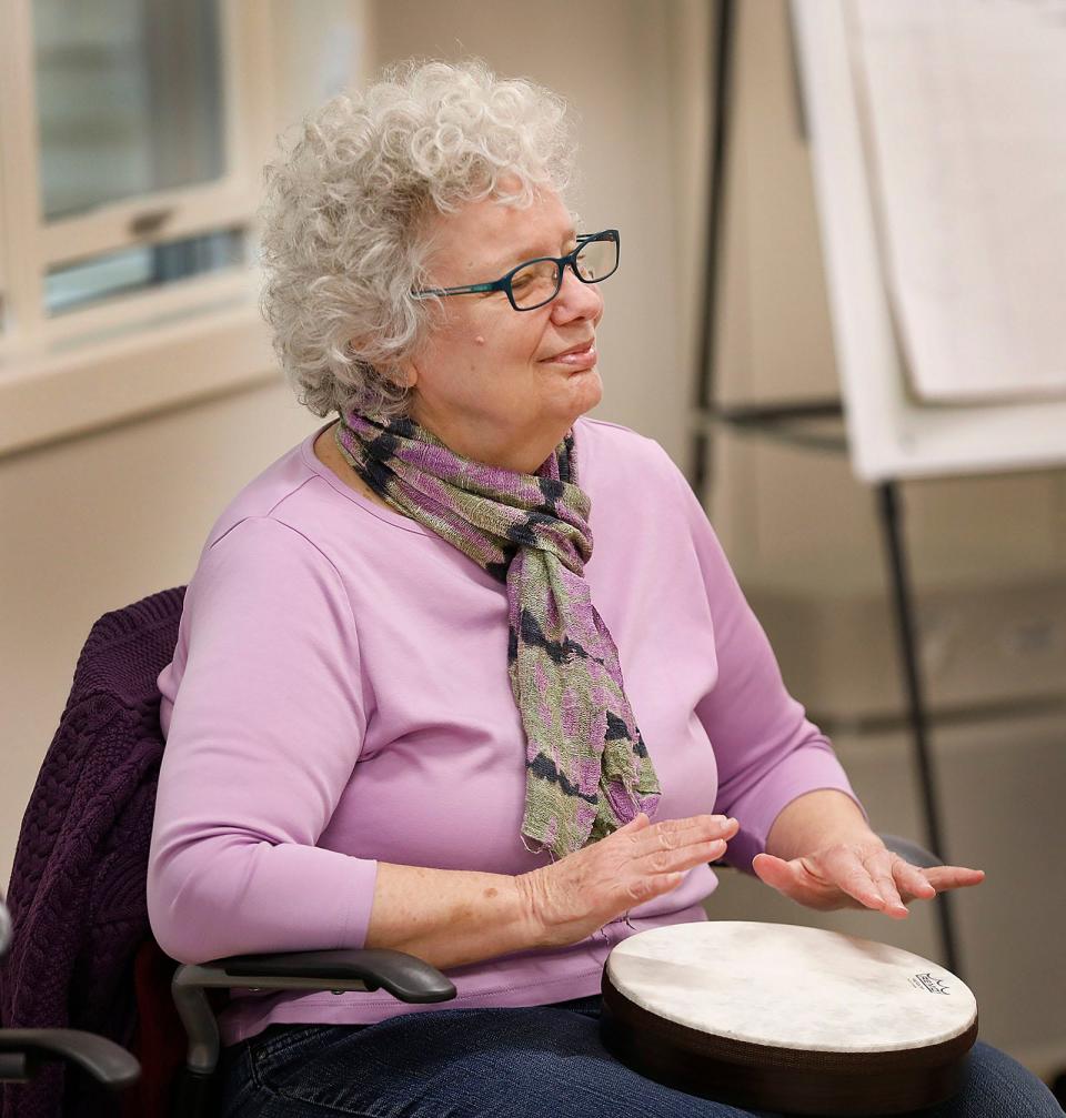 Kris Hewes plays a hand drum to a song by the Beatles as music therapist Rachel Davis, of Sing Explore Create in Rockland, works with seniors at the Milton Senior Center, part of a new six-week music and wellness course called "Let's Make Music," on Wednesday, Oct. 5, 2022.