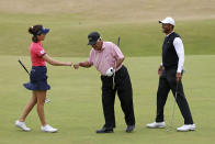 Golf legend Lee Trevino of the United States, greets England's Georgia Hall as Tiger Woods of the US laughs during a 'Champions round' as preparations continue for the British Open golf championship on the Old Course at St. Andrews, Scotland, Monday July 11, 2022. The Open Championship returns to the home of golf on July 14-17, 2022, to celebrate the 150th edition of the sport's oldest championship, which dates to 1860 and was first played at St. Andrews in 1873. (AP Photo/Peter Morrison)